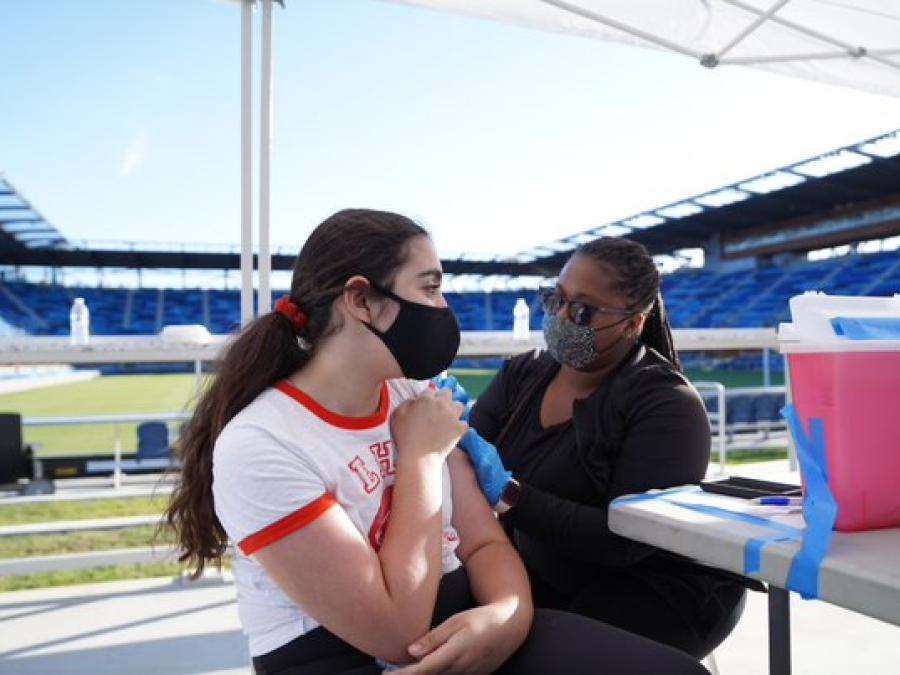 Young person getting vaccinated for COVID-19 at San Jose Earthquakes stadium